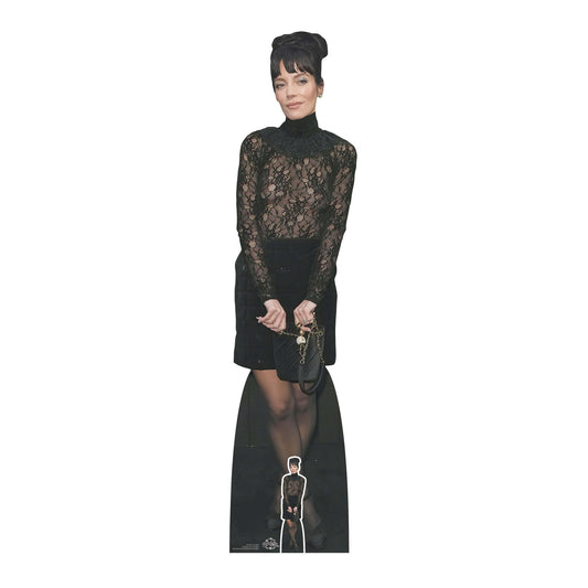 Lifesize cardboard cut out of a female celebrity Lilly Allen with black hair and a black dress, holding an award.