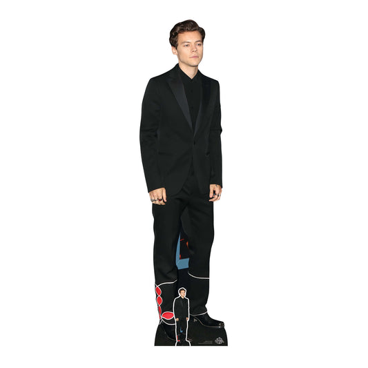 A cardboard cutout of Harry Styles in a black suit with a miniature figure of himself in the background.