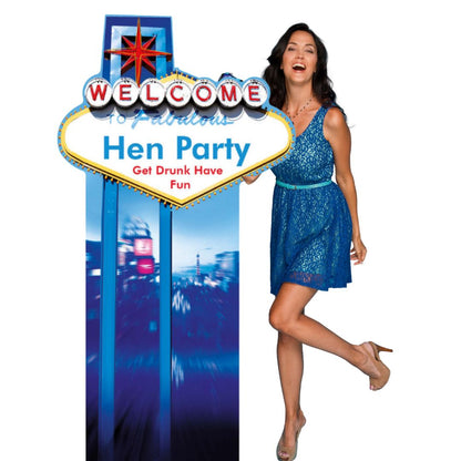 Woman in a blue dress standing next to a 'Welcome to Fabulous Las Vegas Hen Party' sign.