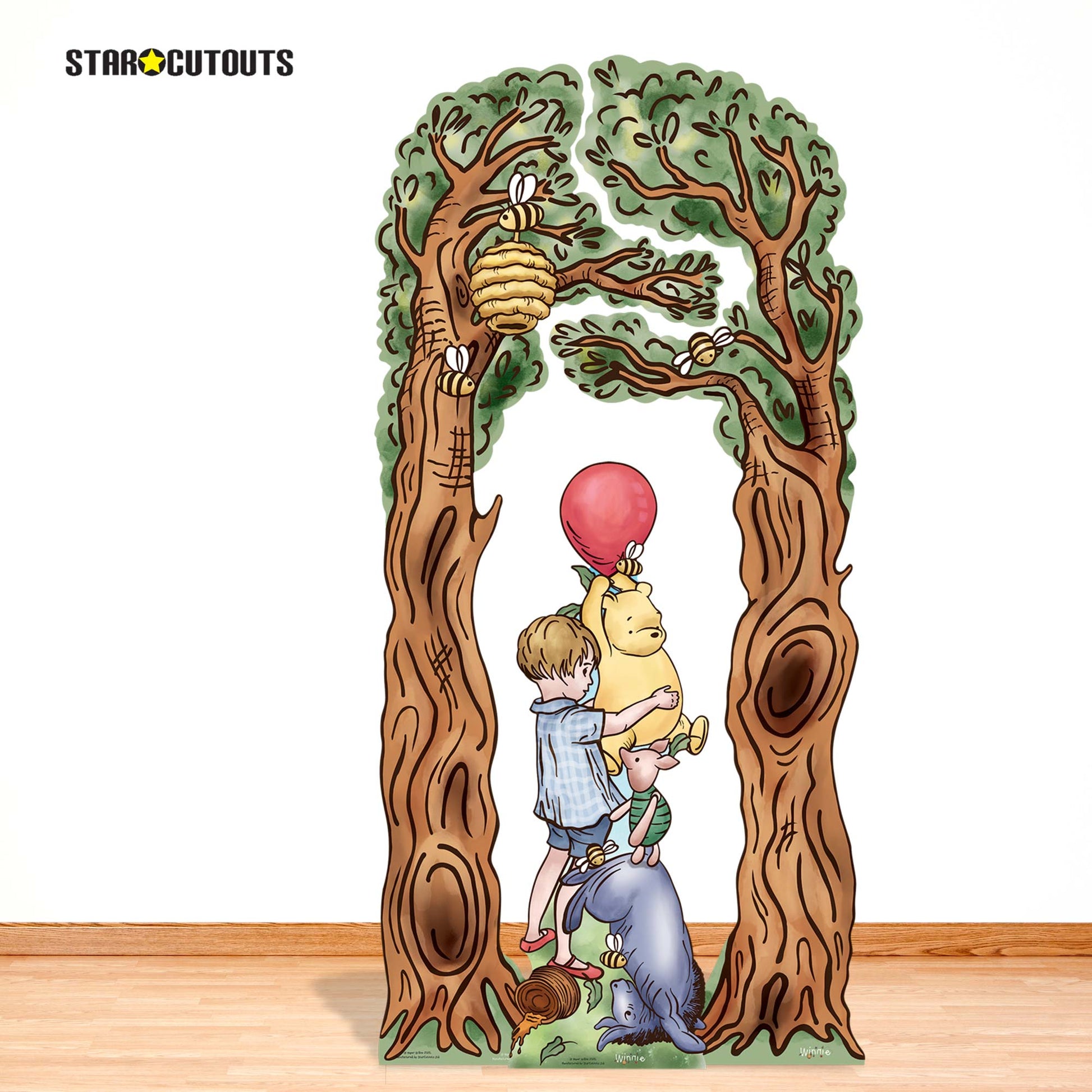 Cardboard cutout of a boy with a dragon and a balloon between two trees, featuring the brand 'Star Cutouts'.