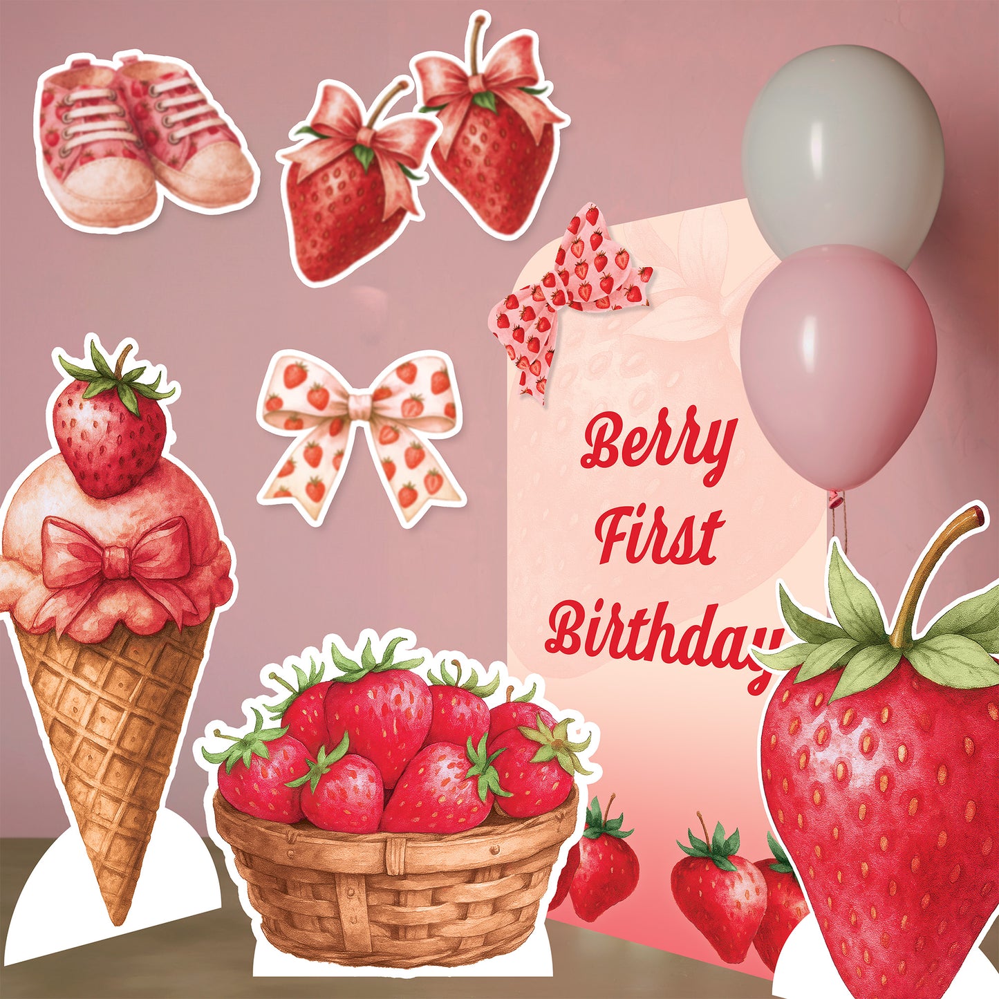 Collection of strawberry-themed birthday party decorations on a pink background
